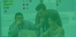 Photo of people gathered around a laptop